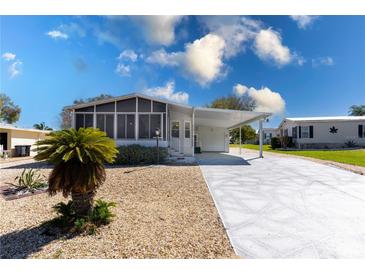 Charming single-story home featuring a screened-in porch and covered parking at 519 Tivoli Park Dr, Davenport, FL 33897