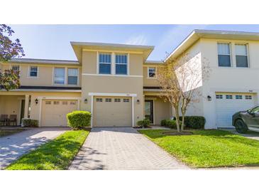Inviting townhome with a well-manicured lawn and a single-car garage with a neutral colored door at 5412 Caramella Dr, Orlando, FL 32829