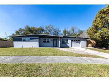 Charming single-story home featuring a gray exterior, well-maintained lawn, and attached garage at 714 Kankakee Ln, Orlando, FL 32807