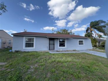 Charming one-story home featuring a well-maintained lawn and inviting curb appeal on a sunny day at 7807 Pine Hawk Ln, Orlando, FL 32822