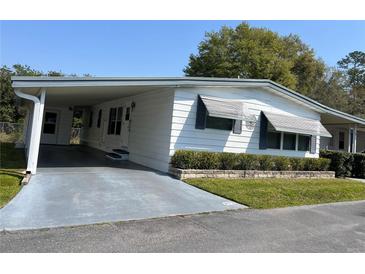 Charming single-story residence features a carport and well-kept landscaping, offering a welcoming curb appeal at 223 Pinewood Dr, Eustis, FL 32726