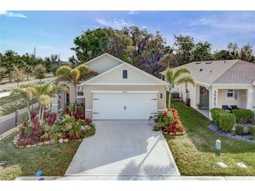Charming single Gathering home featuring a two car garage, tropical landscaping, and a well maintained lawn at 2271 Delhi Pl, Sanford, FL 32771