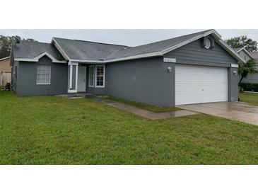 Charming single-story home featuring a well-maintained lawn and attached two-car garage at 236 Bay Head Dr, Kissimmee, FL 34743