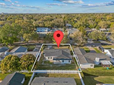 Charming single-story home nestled among mature trees, perfect for peaceful living at 2418 Whitehall Cir, Winter Park, FL 32792