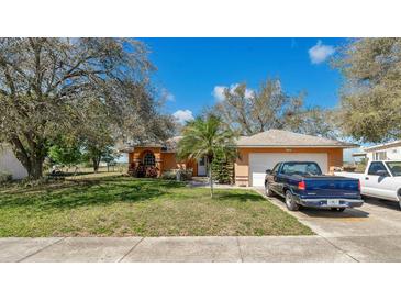 Charming single-story home with mature trees and a well-maintained lawn in a desirable neighborhood at 37149 Sandy Ln, Grand Island, FL 32735