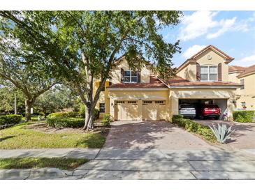 Charming two-story home with a three car garage, tile roof and well-manicured landscaping at 6881 Piazza St, Orlando, FL 32819
