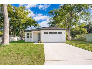 Charming single-story home featuring a well-manicured lawn, neutral paint scheme and a two-car garage at 1104 Grove Manor Dr, Sanford, FL 32771