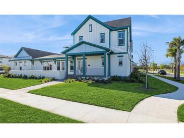 Beautiful two-story home with a covered porch and lush green lawn at 13676 Mcmillan Dr, Orlando, FL 32827