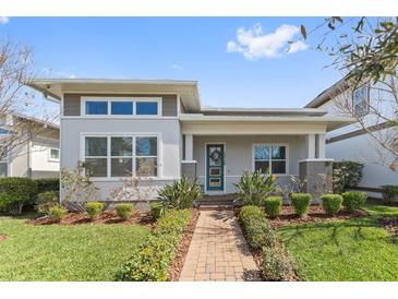 Charming single-story home with well-manicured lawn and inviting front porch, showcasing curb appeal at 13759 Mommsen Ave, Orlando, FL 32827