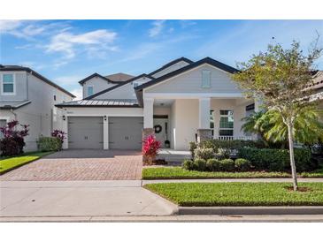 Charming two-story home with well-maintained landscaping, a two-car garage, and covered front porch at 14554 Winter Stay Dr, Winter Garden, FL 34787