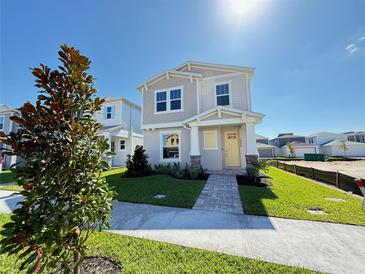 Charming two-story home with yellow door and landscaped front yard under a sunny sky at 1995 Iorio St, St Cloud, FL 34771