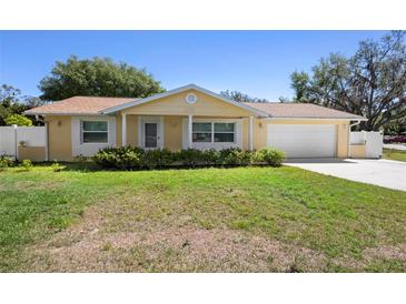Charming single-story home featuring a well-maintained lawn and an attached two-car garage at 333 Crystal Cir, Oviedo, FL 32765