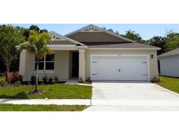 Charming single-story home featuring a well-maintained lawn and a two-car garage at 509 Coronado Cove Rd, New Smyrna Beach, FL 32168