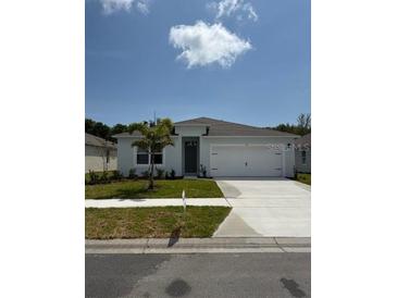 Charming single-story home with a well-manicured lawn and an attached two-car garage at 511 Coronado Cove Rd, New Smyrna Beach, FL 32168