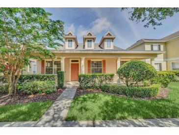 Charming home with a welcoming front porch, dormer windows, and manicured landscaping at 6613 Duncaster St, Windermere, FL 34786
