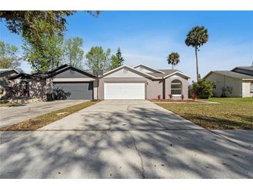 Charming single Gathering home featuring a two-car garage and well-maintained landscaping at 823 Kokomo Cir, Port Orange, FL 32127