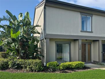 Inviting townhouse featuring well-maintained landscaping, mature plants, and a neutral-colored exterior at 126 Maitland Ave # 126, Altamonte Springs, FL 32701