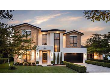 Stunning two-story home featuring a modern design with a brick and stucco exterior, manicured lawn, and professional landscaping at 1402 Stetson St, Orlando, FL 32804
