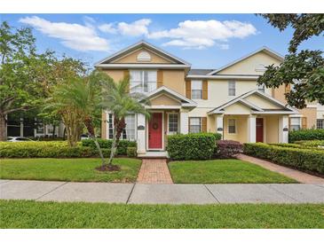 Charming two-story townhome with a brick walkway and a beautifully landscaped front yard at 14467 Prunningwood Pl, Winter Garden, FL 34787