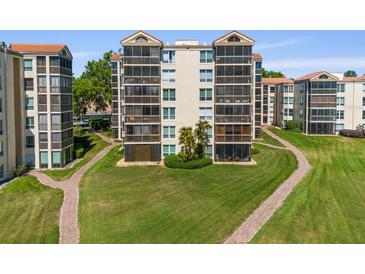 Well-maintained condo building featuring screened patios and lush green landscaping at 204 Quayside Cir # 501, Maitland, FL 32751