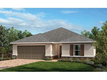 Charming single-story home with attached two car garage, brick driveway, manicured lawn and tasteful landscaping at 3409 Sanctuary Dr, Clermont, FL 34714
