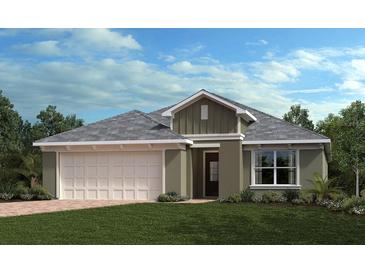 Charming single-story home with a two-car garage, manicured lawn, and classic architectural details at 3465 Sanctuary Dr, Clermont, FL 34714