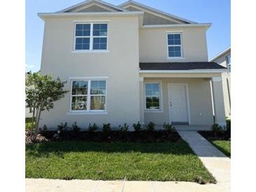 Charming two-story home features a well-maintained lawn, tidy landscaping, and a classic white exterior at 5225 Marshelder St, Apopka, FL 32712
