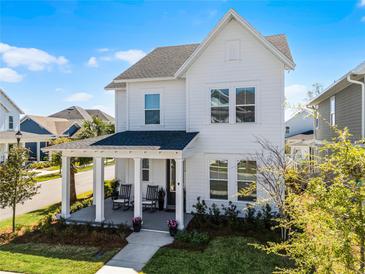 Charming two-story home with a welcoming front porch and a well-manicured lawn at 1118 Eagles Pass Way, Winter Garden, FL 34787