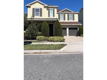 Charming two-story home with a well-manicured lawn and a two-car garage at 11725 Sprawling Oak Dr, Windermere, FL 34786