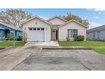 Charming single-story home featuring an attached garage and well-maintained front lawn at 1525 Rivers Edge Dr, Orlando, FL 32825