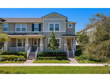 Charming townhome featuring a well-manicured lawn and a welcoming front porch at 15926 Marina Bay Dr, Winter Garden, FL 34787