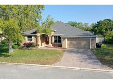 Charming single-story home with a brick driveway, a two-car garage, and a well-maintained lawn at 1924 Eloise Cove Dr, Winter Haven, FL 33884