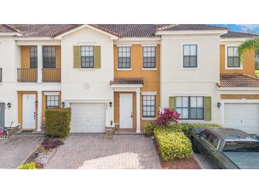 Inviting townhome with a well-manicured lawn, neutral colors, and a one-car garage on a brick paved driveway at 3466 Allegra Cir, St Cloud, FL 34772