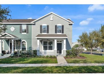 Charming townhome with a welcoming front porch and manicured lawn in a well-maintained community at 502 Rainbow Springs Loop, Groveland, FL 34736