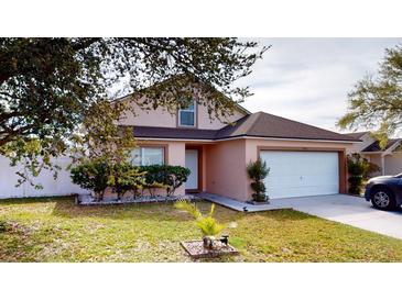 Charming single-Gathering home featuring a well-maintained lawn and a two-car garage at 5132 Luna Negra Dr, Orlando, FL 32811