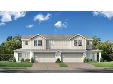 Charming new two-story home with symmetrical design, individual garages, and beautiful blue sky at 6469 Horseshoe Lane Way, St Cloud, FL 34773