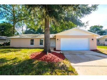 Charming single-story home with mature trees and a well-maintained lawn at 100 Huntswood Ct, Longwood, FL 32750