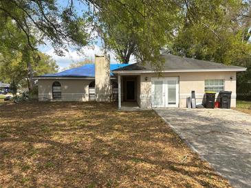 Single story home with a chimney, front entrance and concrete driveway at 1060 Walt Williams Rd, Lakeland, FL 33809