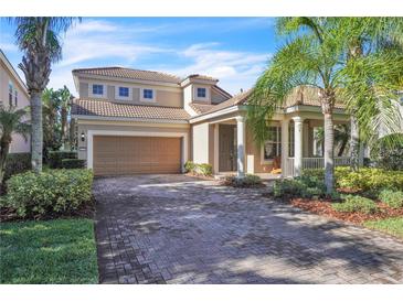 Charming two-story home featuring a two-car garage, tiled roof, and lush landscaping in a serene neighborhood at 11754 Barletta Dr, Orlando, FL 32827