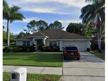 Charming single story home with a well manicured lawn, mature landscaping, and a two car garage at 1201 Thornbury Ct, Winter Garden, FL 34787