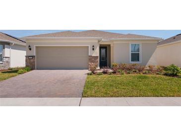 Charming single-story home with a two-car garage, paver driveway, and well-maintained lawn and landscaping at 6403 Shimmering Shores Ln, St Cloud, FL 34771