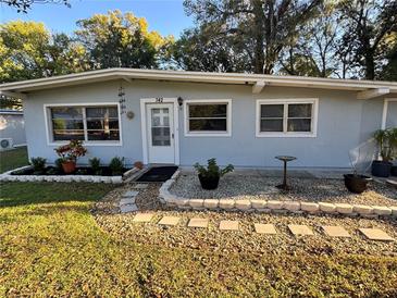 Charming single-story home with a well-manicured lawn and inviting front yard landscaping at 742 Valencia Ave, Orange City, FL 32763