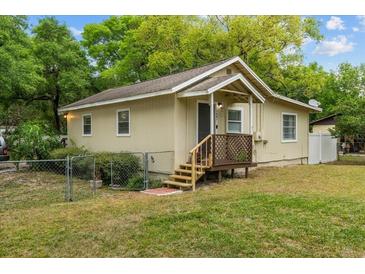 Charming single-story home featuring a cozy front porch, well-maintained lawn, and mature trees at 1401 E Voorhis Ave, Deland, FL 32724