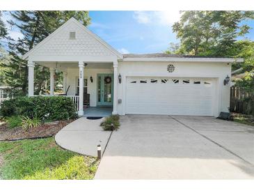 Charming single-story home showcasing a well-maintained lawn and a welcoming front porch with a double-door entry at 322 N Rhodes St, Mount Dora, FL 32757