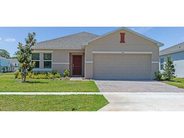Charming single-story home features manicured lawn, brick driveway and neutral tones at 144 Jones Fish Camp Rd, Edgewater, FL 32141