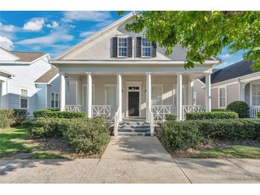 Charming front exterior featuring a column-lined porch and well-maintained landscaping at 202 Longview Ave, Kissimmee, FL 34747