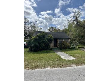 Charming home featuring a walkway, lush greenery, and an inviting atmosphere, perfect for serene living at 218 Franklin St, Ocoee, FL 34761