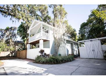 Charming two-story home with front yard landscaping and white picket fence at 2211 Oberlin Ave, Orlando, FL 32804