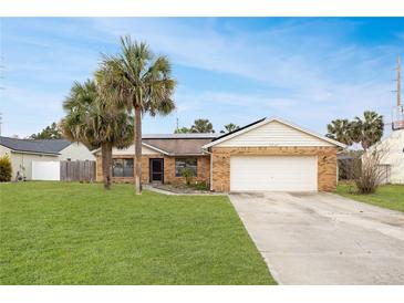 Charming single-story brick home features a well-manicured lawn and mature palm trees at 3093 S Horizon Pl, Oviedo, FL 32765