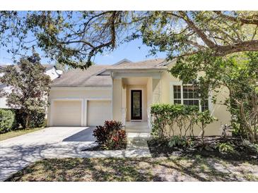 Charming home with two-car garage, manicured landscaping, and a covered entryway at 10081 Cobalt Bay Rd, Orlando, FL 32827